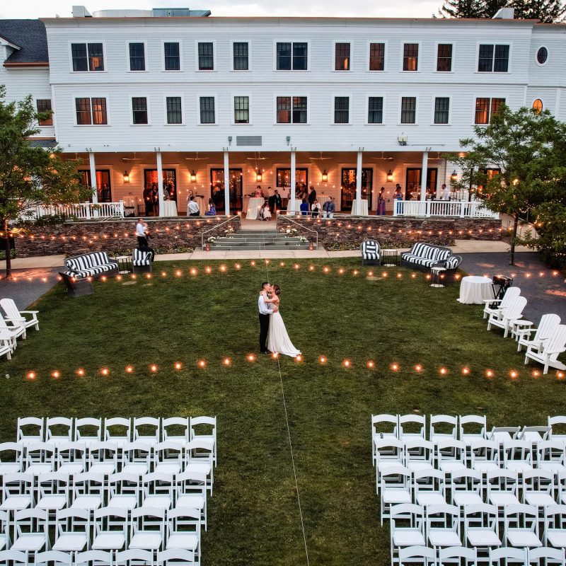 bride and groom under the lights at the Taconic Hotel in Manchester, VT