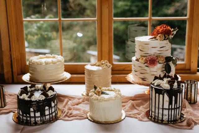A table full of wedding cakes