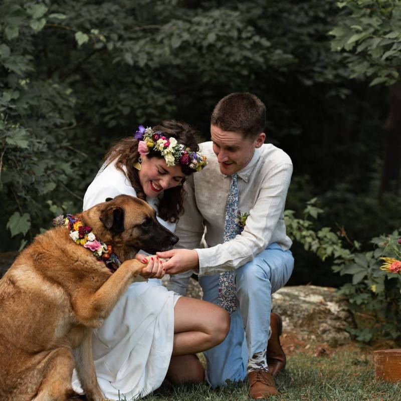 Couple posing with their dog during elopement ceremony in VT