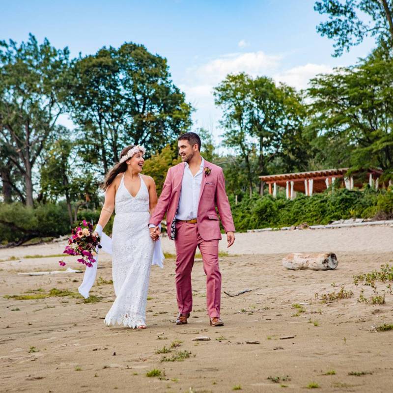 Couple walking on Burlington lakefront beach during Vermont wedding