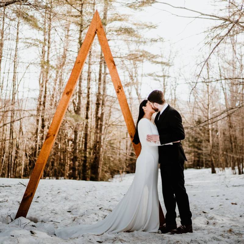 Couple kissing after winter elopement ceremony in Vermont