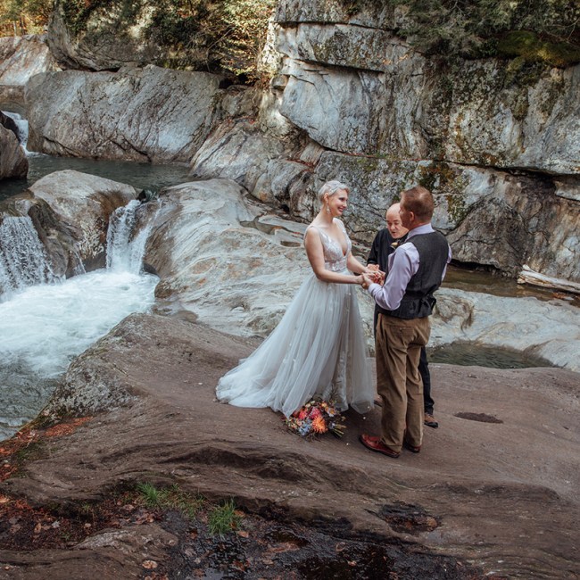 A photo of a couple's elopement ceremony at Warren Falls, Vermont