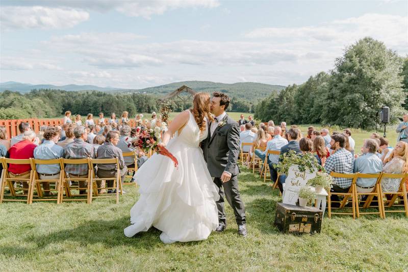 Couple kissing after outdoor wedding ceremony in Vermont