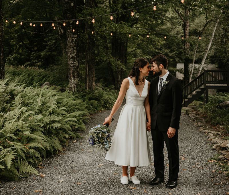 Bride and groom kissing in the woods during Vermont wedding