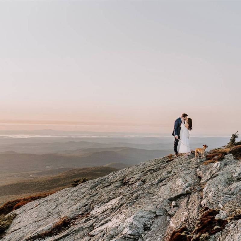 Couple on top of Mt Mansfield with dog during Vermont elopement ceremony at sunset