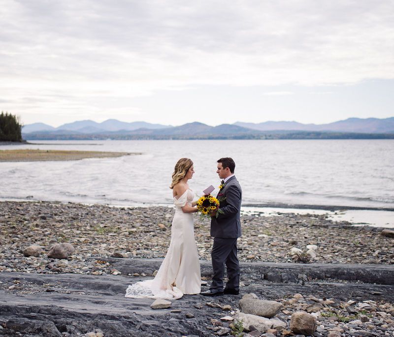 White couple sharing private vows on the shore of Lake Champlain in Vermont