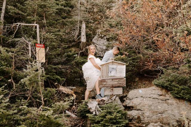 A white couple pops champagne after getting married at Sterling Ridge Resort, VT