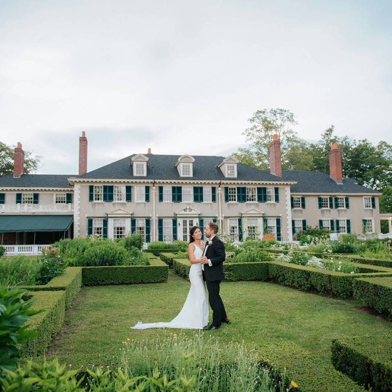 Bride and groom on the lawn at VT historic estate